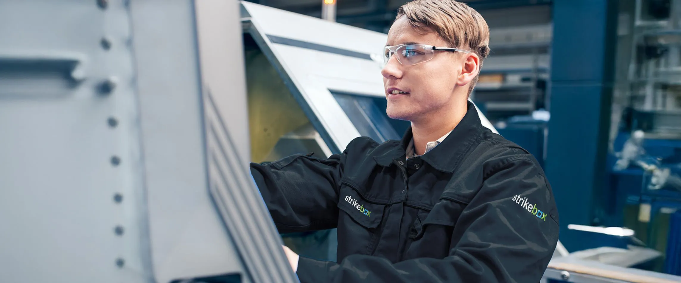 young employee in strikebox overalls